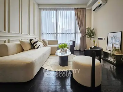 Elegant modern living room with stylish furniture and large window for natural light.