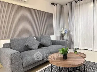 Stylish modern living room with gray sofa and elegant decor