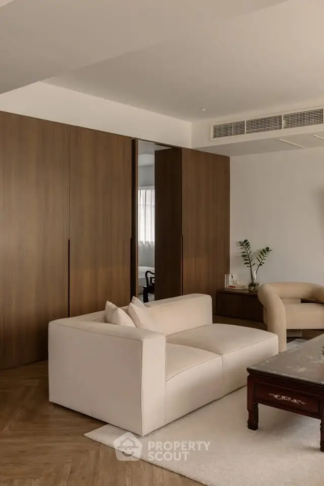 Elegant living room with modern furniture and wooden accents, perfect for stylish urban living.
