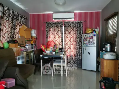 Cozy living room with eclectic decor and compact dining area