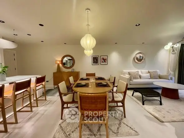 Spacious modern living room with elegant dining area and stylish lighting.