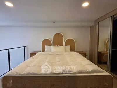 Spacious bedroom with elegant bed and modern decor, perfect for relaxation and comfort.