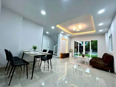 Spacious modern living room with elegant dining area and garden view