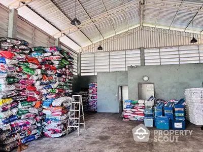 Spacious warehouse interior with high ceiling and organized storage