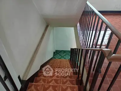 Charming staircase with vintage tiles leading to a cozy interior space, perfect for a warm home ambiance.