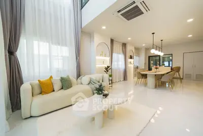 Luxurious open-plan living room with elegant decor and modern dining area