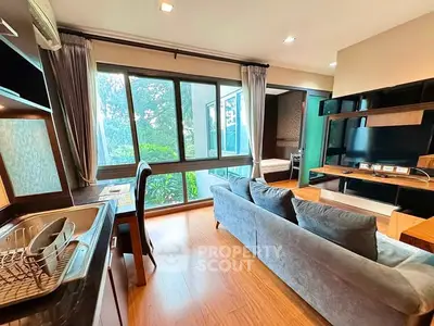 Modern living room with large windows and stylish furniture in a cozy apartment.