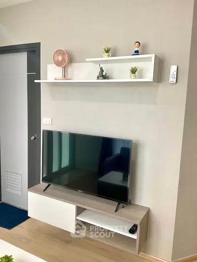 Modern living room with sleek TV stand and decorative shelves, perfect for stylish urban living.