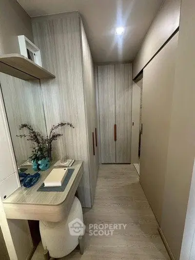 Modern hallway with stylish wooden cabinets and a sleek desk, perfect for a compact home office setup.