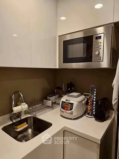 Modern kitchen with sleek appliances and compact design