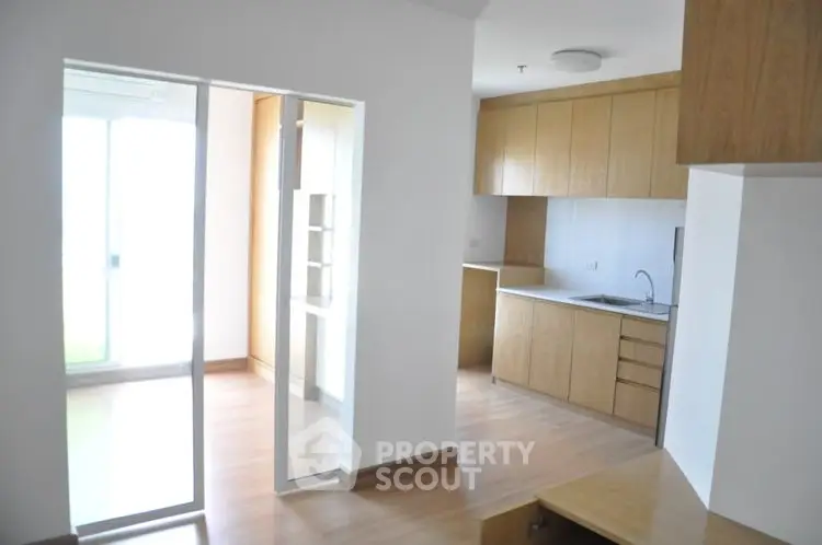 Modern apartment interior with open kitchen and wooden cabinetry