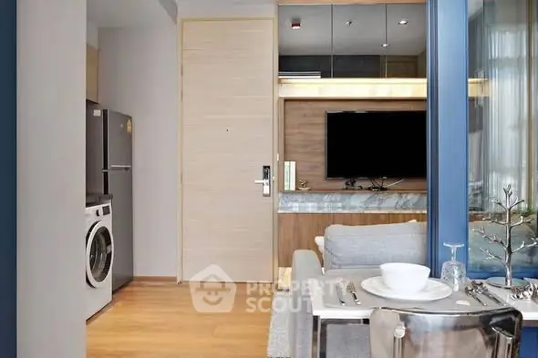 Modern apartment interior with open layout, featuring a sleek kitchen and cozy living area.
