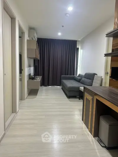 Modern living room with sleek furniture and wooden flooring