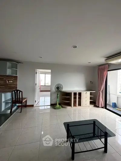 Spacious living room with modern furniture and large windows for natural light.