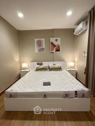 Modern bedroom with stylish decor and air conditioning in a cozy apartment.