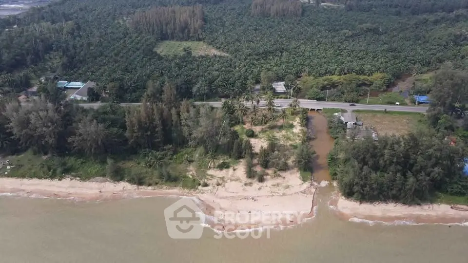 Stunning beachfront property with lush greenery and direct ocean access, perfect for development.