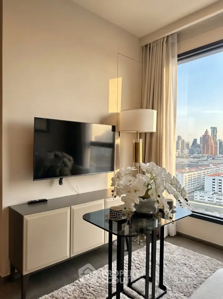 Modern living room with city view, featuring sleek TV setup and elegant decor.