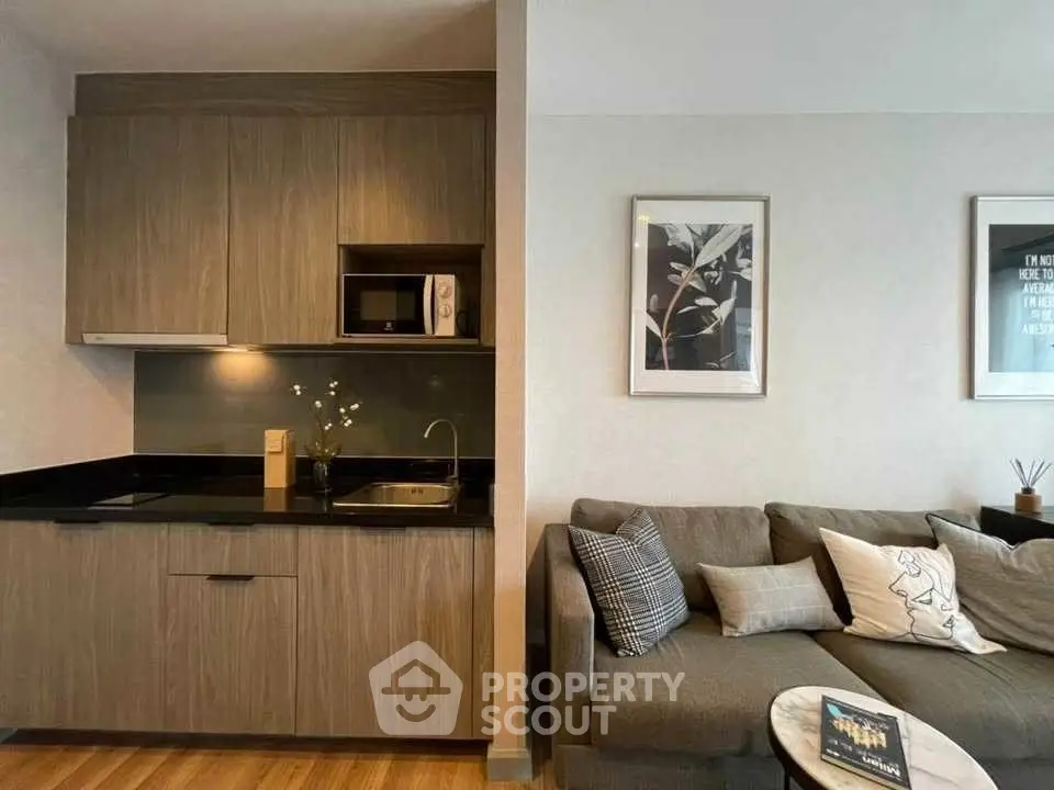 Modern studio apartment with sleek kitchen and cozy living area, perfect for urban living.