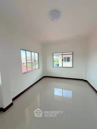 Bright and spacious empty room with large windows and glossy floor, perfect for customization.