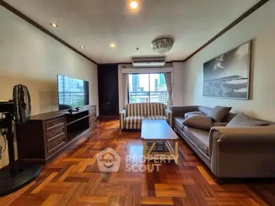 Spacious living room with elegant parquet flooring and modern furnishings in a high-rise apartment.