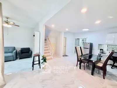 Spacious open-plan living and dining area with modern furnishings and marble flooring.