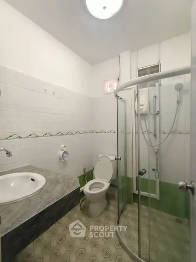 Spacious bathroom with modern shower and unique tile flooring
