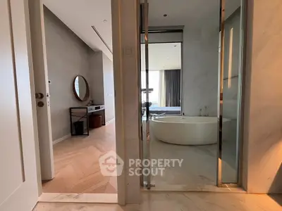 Luxurious modern apartment with elegant bathroom and stylish bedroom, featuring a freestanding bathtub and chic decor.