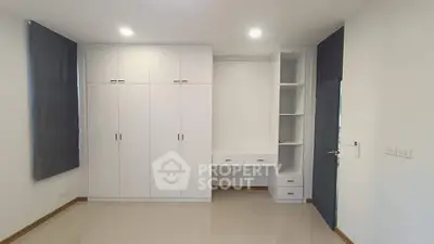 Spacious bedroom with built-in wardrobe and study desk, perfect for modern living.