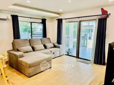 Spacious living room with modern sofa and large windows for natural light