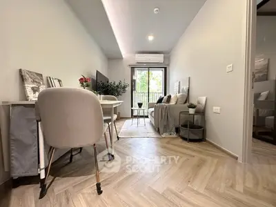 Modern living room with stylish decor and natural light, featuring a cozy seating area and elegant dining space.