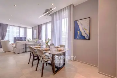 Luxurious open-plan living and dining area with elegant decor and natural light.