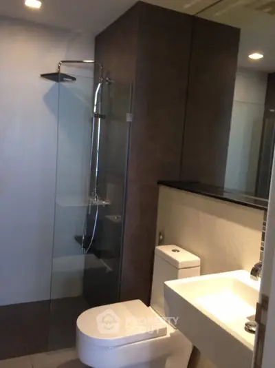 Modern bathroom with sleek shower and contemporary fixtures.