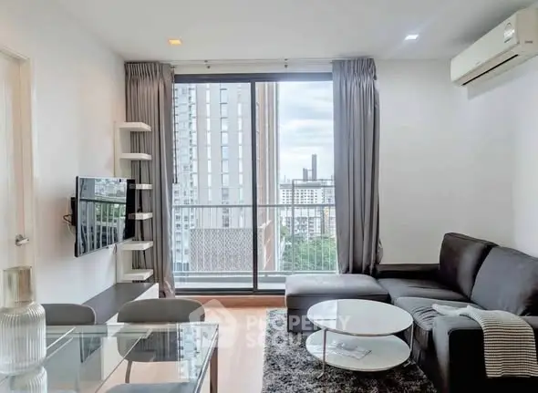 Modern living room with city view, sleek furniture, and large windows.