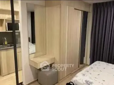 Modern bedroom with built-in wardrobe and cozy decor in a stylish apartment.