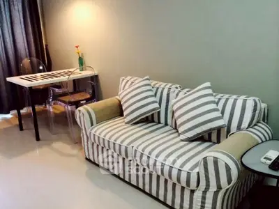 Cozy living room with striped sofa and modern dining table, perfect for urban living.