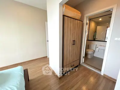Modern bedroom with ensuite bathroom and wooden flooring