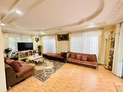 Spacious living room with elegant ceiling design and ample natural light