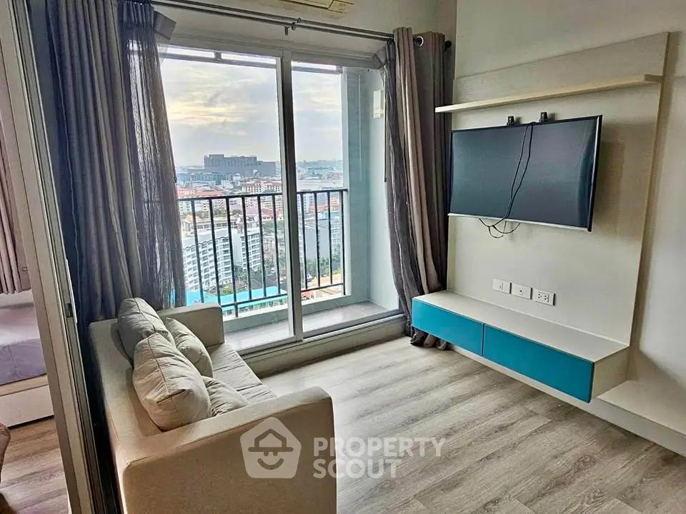Modern living room with balcony view in high-rise apartment