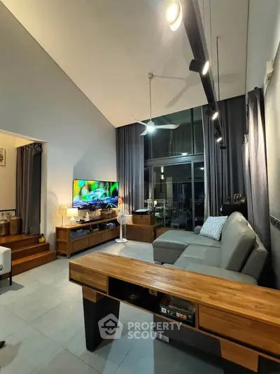 Spacious modern living room with high ceiling and stylish furniture