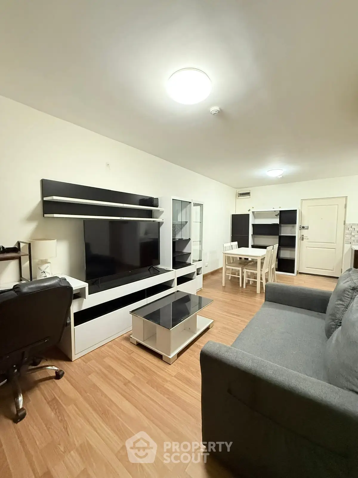 Modern living room with sleek furniture and wooden flooring