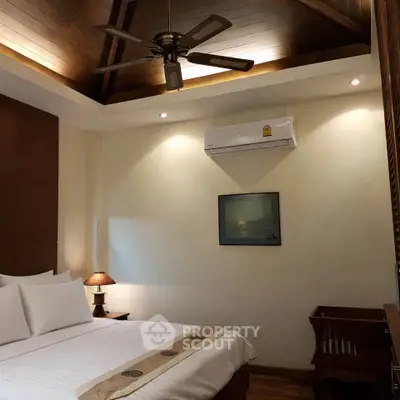 Luxurious bedroom with elegant wooden ceiling and modern air conditioning unit.