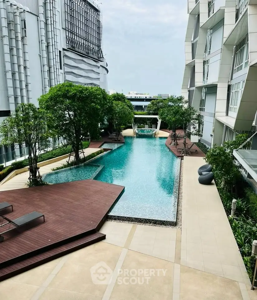 Luxurious modern apartment complex with stunning pool and lush greenery