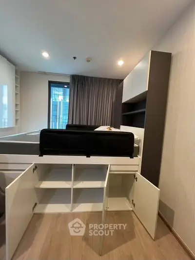Modern bedroom with built-in storage and large window view