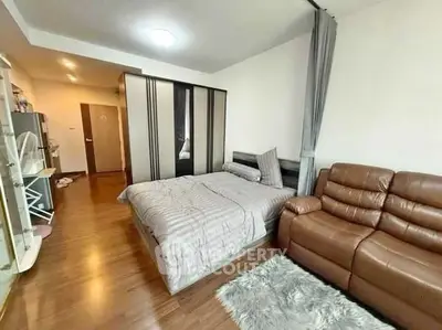 Cozy bedroom with modern decor and comfortable seating area