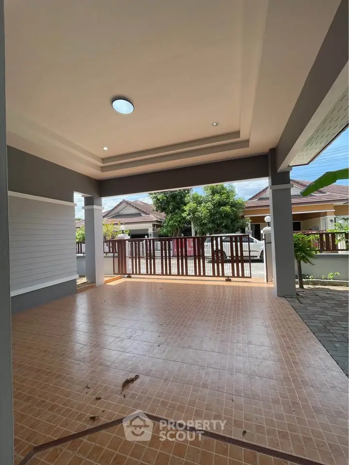 Spacious covered patio with tiled flooring and garden view in modern home