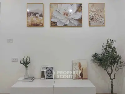 Elegant living room with stylish decor and modern art pieces on the wall.