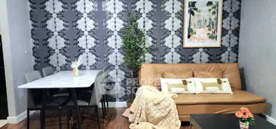 Stylish living room with modern decor, featuring a cozy sofa, elegant dining table, and chic wall art.
