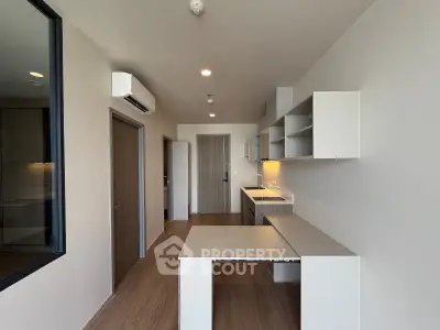 Modern kitchen with sleek cabinetry and integrated appliances in a stylish apartment.