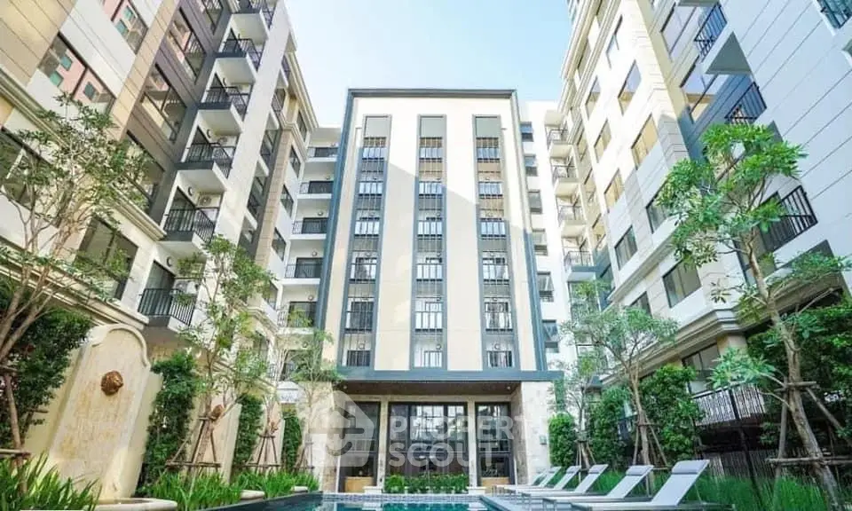 Luxurious residential building with pool and lush greenery, perfect for modern living.
