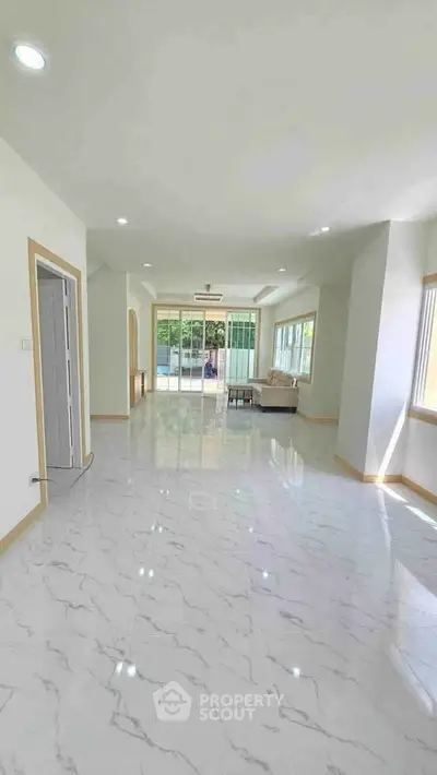 Spacious and bright living room with modern design and large windows for natural light.